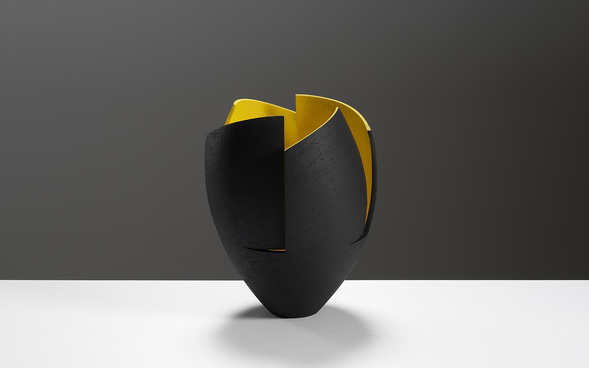 Black cut and altered vessel with yellow interior