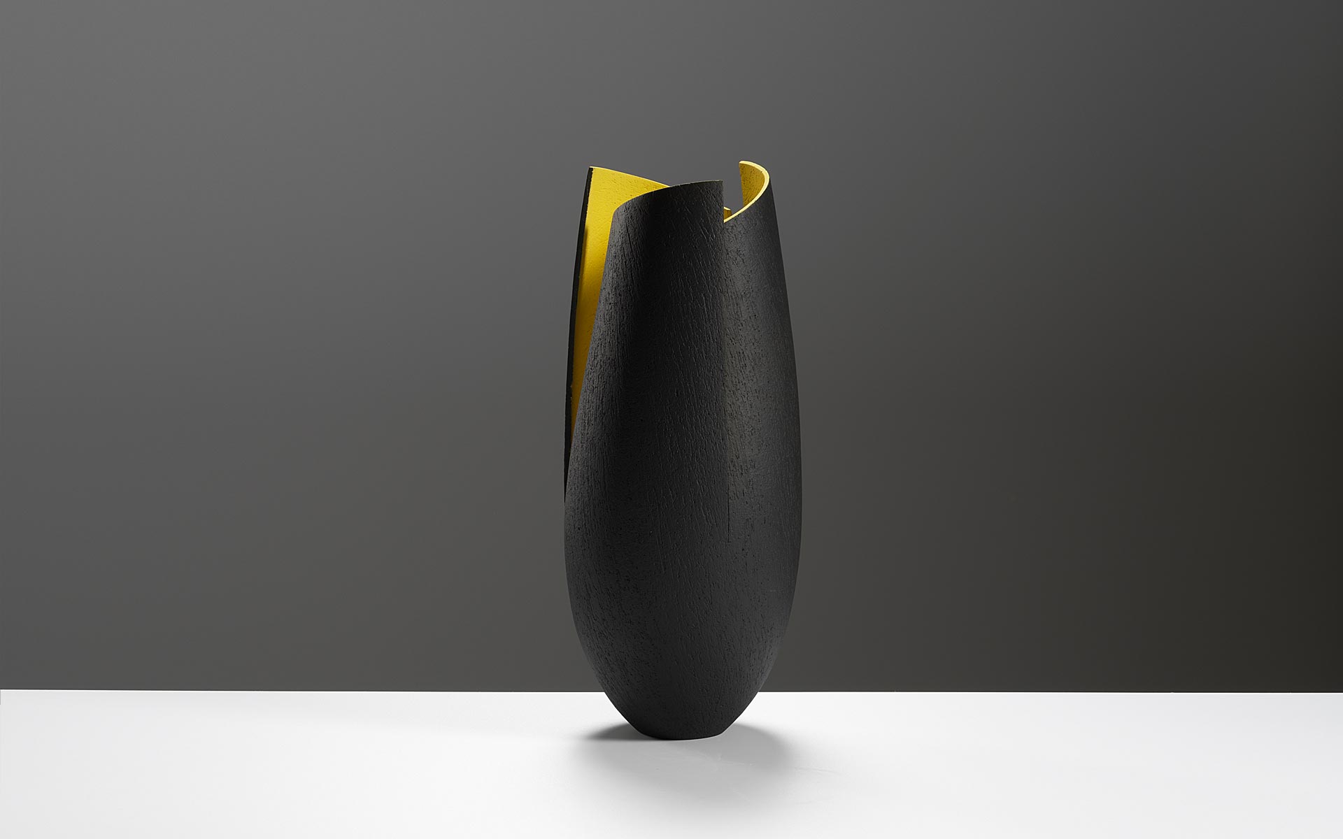 Slim cut and altered black vessel with yellow interior